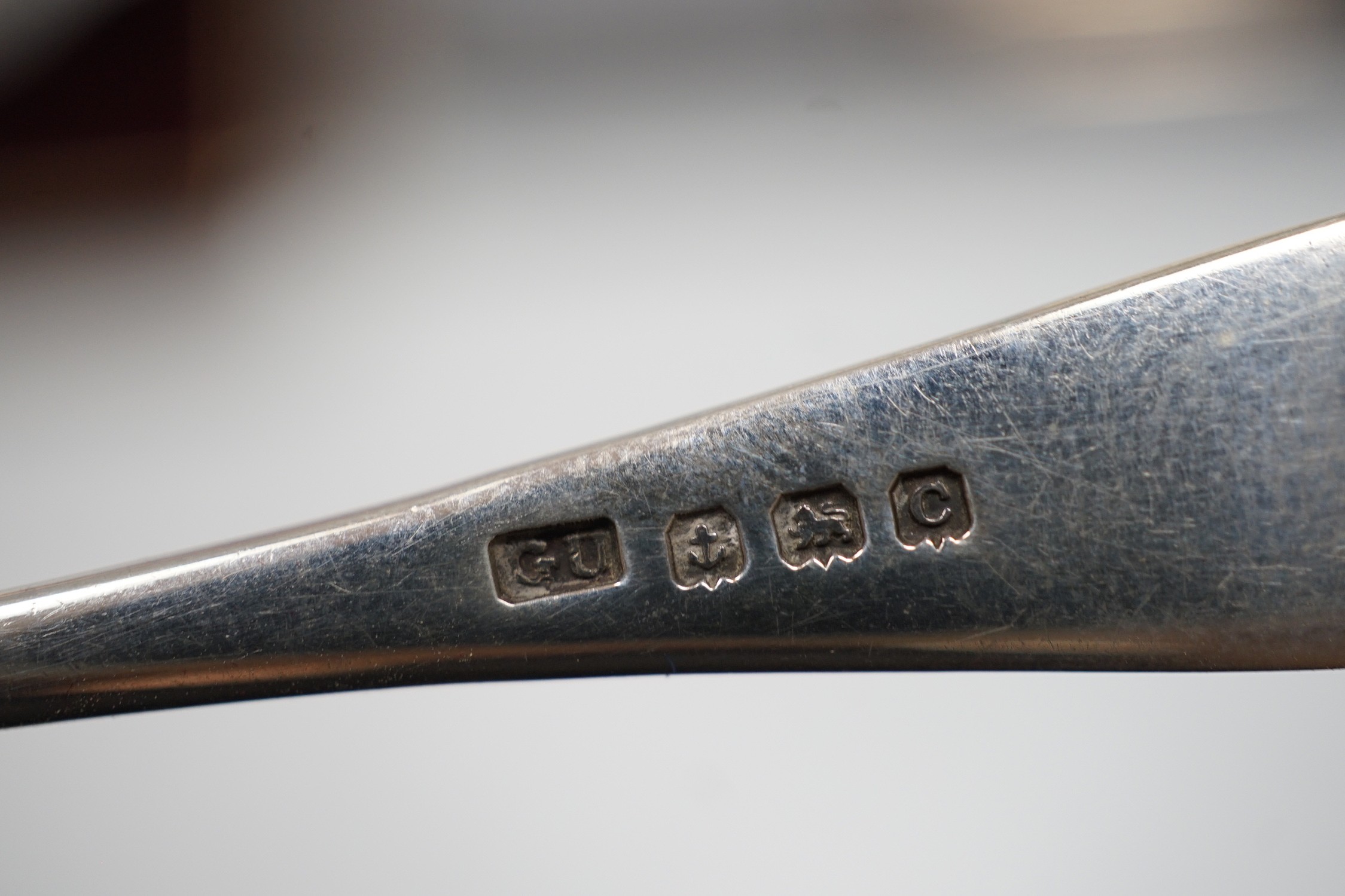 A set of six tea knives, an Edwardian silver butter shell and knife and a set of six silver coffee spoons, all cased.